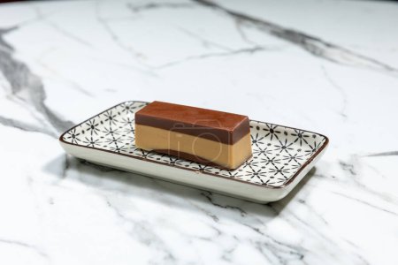 Foto de Nougat praline, delicious mix of nougat and almond creme chocolate served on a plate - Imagen libre de derechos