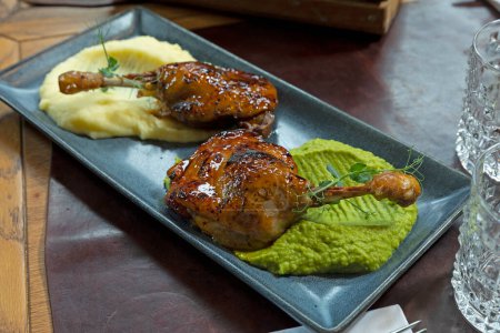 Photo for Duck drumstick with home made maple syrup on two kinds of puree - Royalty Free Image