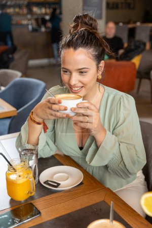 Photo for Beautiful woman drinking coffee in the cafe bar - Royalty Free Image
