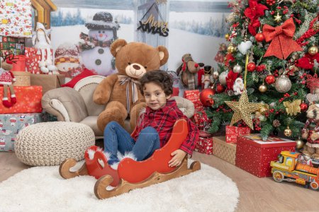 Foto de Kid playing with Christmas presents - Imagen libre de derechos