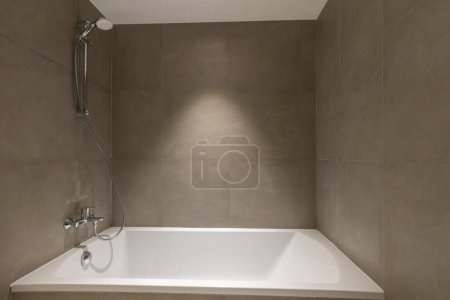 Photo for Bathtub in small bathroom interior - Royalty Free Image