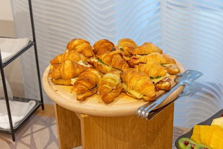 Photo for Croissant sandwiches served on a wooden board - Royalty Free Image