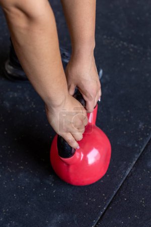 Photo for Woman hands holding kettlebell closeup photo - Royalty Free Image