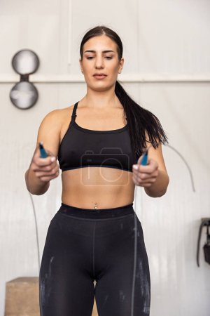 Photo for Fitness woman jumping on skipping rope in the gym - Royalty Free Image