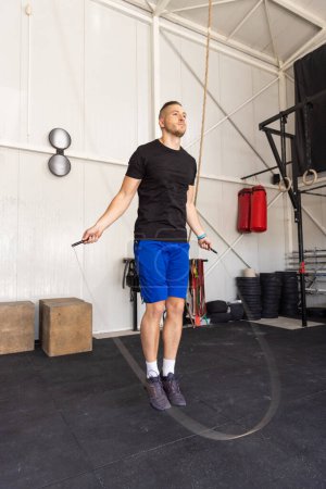 Photo for Man jumping on skipping rope in the gym - Royalty Free Image