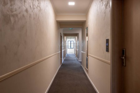 Photo for Interior of a carpeted hotel corridor doorway - Royalty Free Image