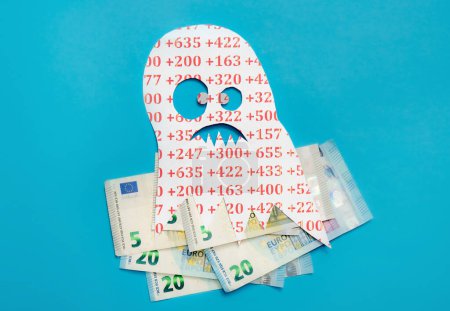 Photo for Conceptual image of Euribor as in scary monster floating above Euro money bank notes on blue studio background. - Royalty Free Image