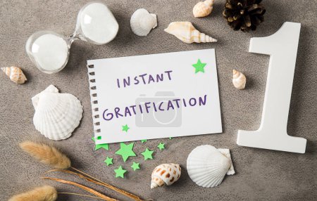 Concept of instant gratification. Text on paper decorated with seashells indoors studio shot.