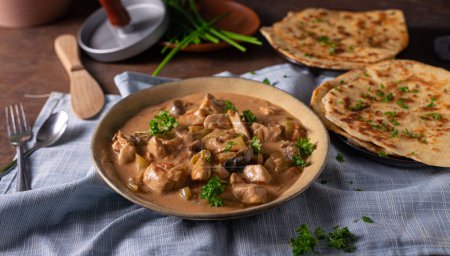Photo for Tikka masala with herbs and homemade naan bread - Royalty Free Image
