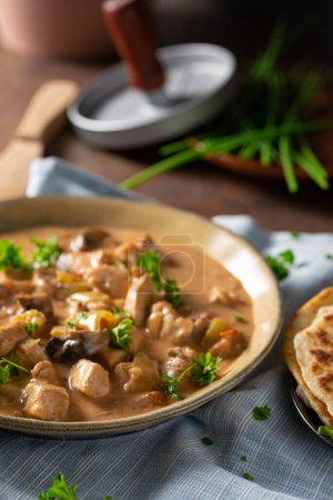 Photo for Tikka masala with herbs and homemade naan bread - Royalty Free Image