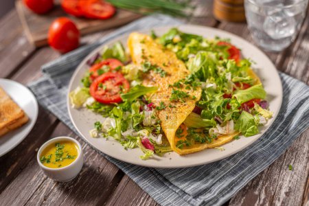 Photo for Delicious eggs omelette with salad and vegetable - Royalty Free Image