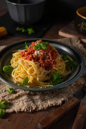 Photo for Delicious pasta with basil, parmesan cheese and bolognese sauce - Royalty Free Image