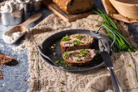 Photo for Bio organic pate with herbs and garlic, spread on bread - Royalty Free Image