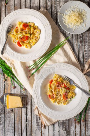 Photo for Delicious pasta stuffed with meat and creame sauce with garlic and herbs - Royalty Free Image
