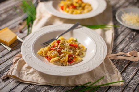 Photo for Delicious pasta stuffed with meat and creame sauce with garlic and herbs - Royalty Free Image