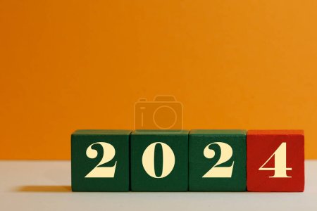 wooden cubes indicating in change of year new year 2024 concept calendar planning party planning
