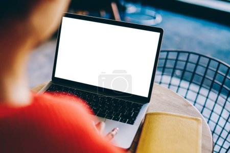 Photo for Blurred back view of young woman working on freelance at modern laptop device with blank screen area for your internet content.Digital netbook with copy space area for website or advertising text - Royalty Free Image