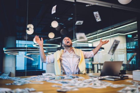 Cheerful delight business investor happy with good exchange of bitcoin at online stock platform, excited man earning dividend rejoicing with lottery winning at sports betting tossing up money