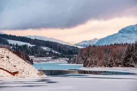 Frozen Laggan Dam in the Scottish Highlands at sunset