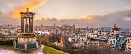 Photo for Calton Hill panoramic view of the Edinburgh skyline at sunset, with the Dugald Stewart monument in the foreground - Royalty Free Image