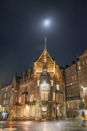 A night scene of old buildings on the corner of Market Street and Cockburn Street, under the moon. Edinburgh, Scotland
