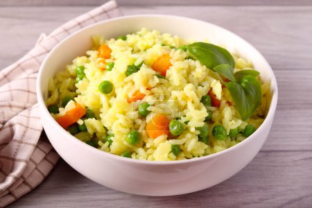 Photo for Rice with carrots and peas in a bowl - Royalty Free Image