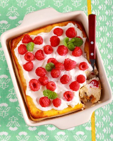 Photo for Sweet cheese pudding with sour cream and raspberry on top - Royalty Free Image