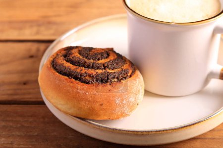 Photo for Poppy seed filling swirl buns on plate - Royalty Free Image