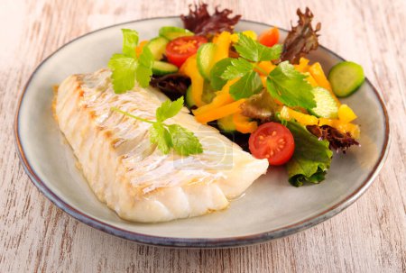 Téléchargez les photos : Cod fillet and salad on plate - en image libre de droit