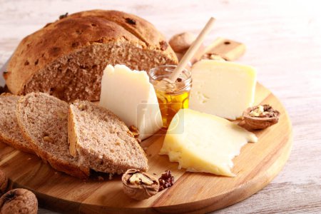 Photo for Cheese board with walnut bread and honey - Royalty Free Image