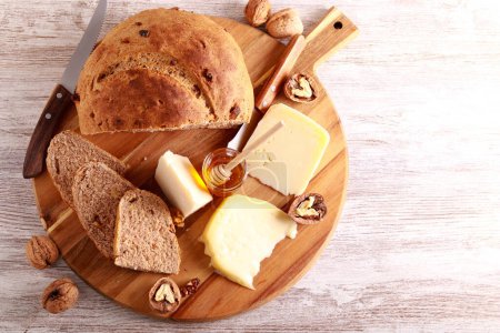 Photo for Cheese board with walnut bread and honey - Royalty Free Image
