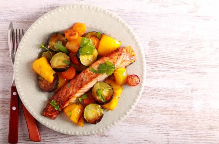 Photo for Pescatarian dinner - roast salmon with vegetables on plate - Royalty Free Image