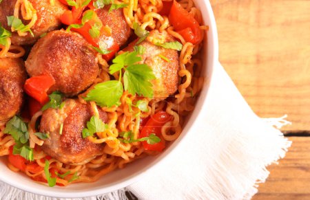 Photo for Meatballs with pepper and noodles in a bowl - Royalty Free Image
