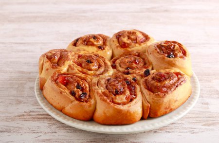Photo for Classic Chelsea buns, rolls with dried fruits, on plate - Royalty Free Image