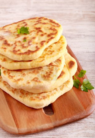 Photo for Homemade flatbreads on wooden board - Royalty Free Image