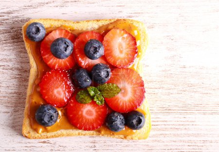 Photo for Toast with peanut butter blueberry and strawberry - Royalty Free Image