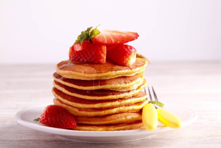 Photo for Sweet potato pancakes with honey and strawberry - Royalty Free Image