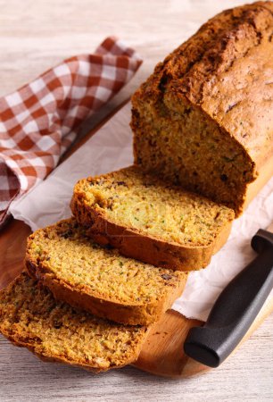 Photo for Zucchini and nuts cake, sliced on wooden board - Royalty Free Image