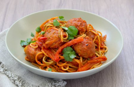 Photo for Tricolour spaghetti with vegetables and beef meatballs in tomato sauce - Royalty Free Image