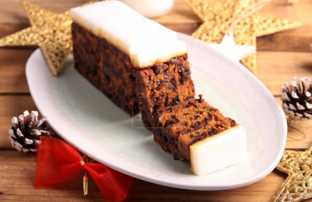 Photo for Christmas fruit cake with icing, sliced, selective focus - Royalty Free Image