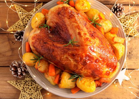 Luxury turkey crown, festive roast breast of turkey with potatoes and carrot