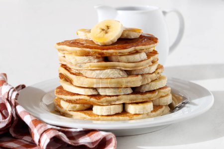 Photo for Pile of banana pancakes with honey on plate - Royalty Free Image