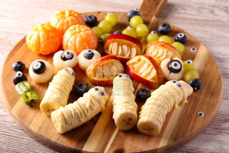 Photo for Halloween fruit platter. Assorted fruit snacks decorated for Halloween - Royalty Free Image