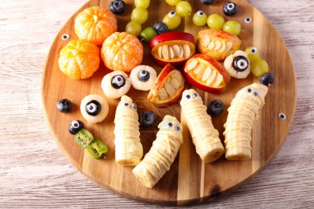 Photo for Halloween fruit platter. Assorted fruit snacks decorated for Halloween - Royalty Free Image