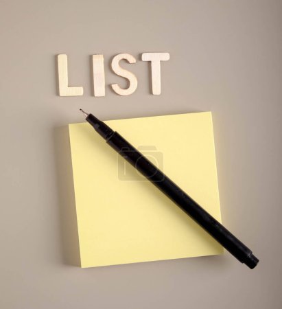 Photo for Empty note sticky paper with pen and word list over grey background - Royalty Free Image