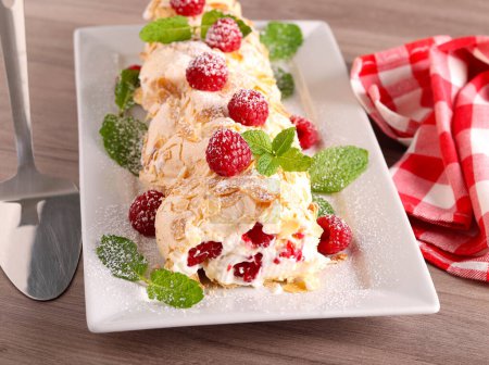 Photo for Raspberry merengue roulade, sweet roll with cream and raspberry - Royalty Free Image