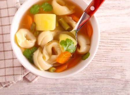 Photo for Soup with tortellini and vegetables in a bowl - Royalty Free Image