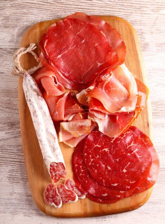 Photo for Cold cuts assortment of sliced meat and sausages - Royalty Free Image