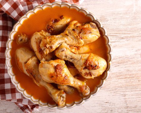 Photo for Chicken drumsticks with gravy sauce in a bowl - Royalty Free Image