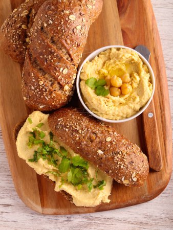 Photo for Seed brown buns with homemade hummus spread - Royalty Free Image